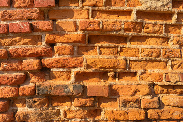 Old crumbling red brick wall