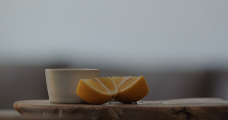sliced sweet lemon on olive board