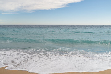 Empty sand beach on Mediterranean sea with horizon line vacation background