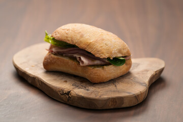 Ciabatta sandwich with ham and pesto closeup