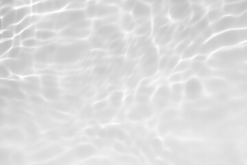 White water with ripples on the surface. Defocus blurred transparent white colored clear calm water surface texture with splashes and bubbles. Water waves with shining pattern texture background.