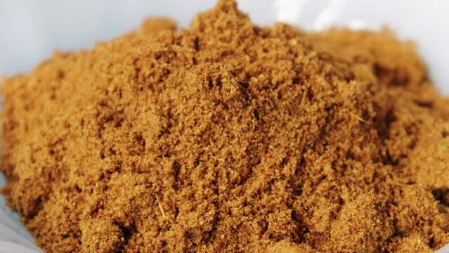  A mixture of curry spices rotates closeup. 4k. Garam masala or spice powder rotate in a bowl. Top view. Closeup shot. Mixture of garam masala powder background.
