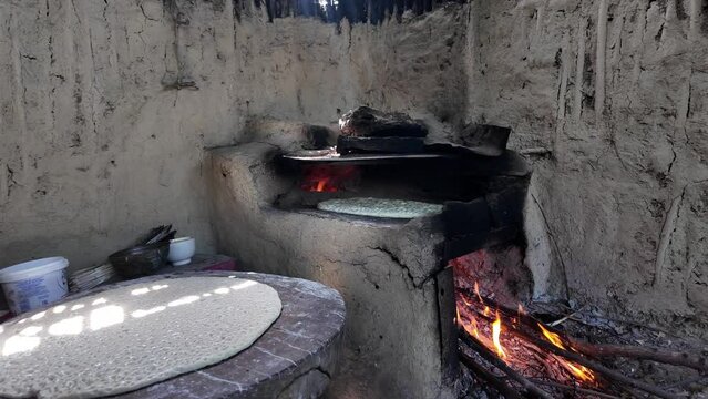 preparing bread in a traditional Dagestan village bakery. Bread is a flatbread baked in a Koryuk oven, common in the cuisine of the North Caucasus.