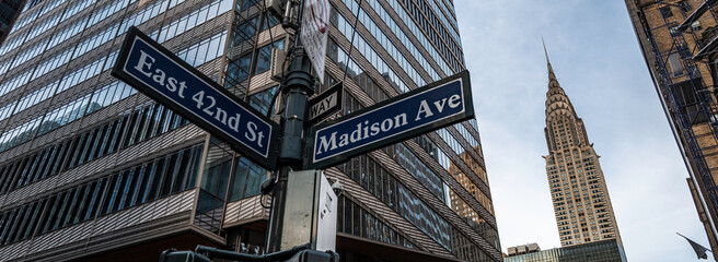 street signs and skyscraper in new york city