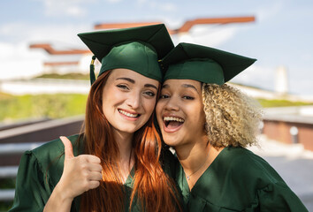 Two Happy Graduates Celebrating Together