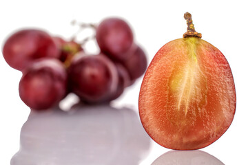 One half of a berry and one bunch of grapes, macro, isolated on white background.