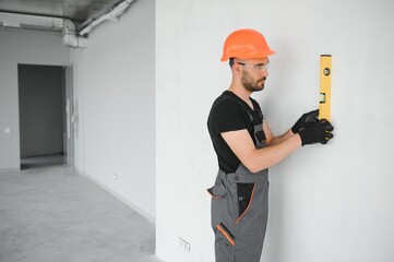 Construction Worker in uniform with spirit level