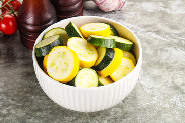 Sliced raw young green and yellow zucchini