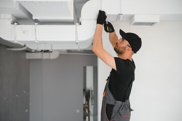 hvac technician at work. ventilation, heating system maintenance and repair