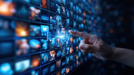Fototapeta premium Hand interacting with digital interface displaying multiple videos and images. Technology, multimedia concept, futuristic digital touch screen.