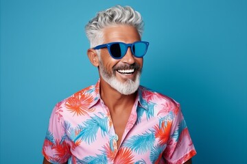 Portrait of happy senior man with grey hair wearing sunglasses and colorful shirt