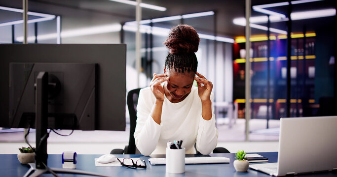 Exhausted Businesswoman Working on Computer in Office, Fighting Stress
