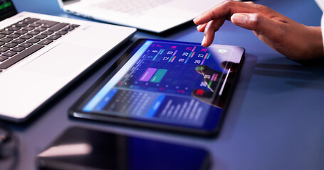 African American woman using electronic tablet to schedule appointments