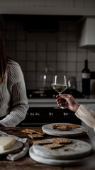 person sitting at table and drinking wine, champagne glass on the table, dinner background