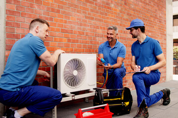 Skilled HVAC technician inspects commercial air conditioners to ensure safe