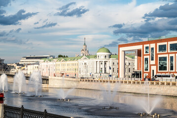 An urban landscape with fountains on the river