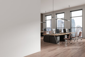 Office coworking interior with tables and pc monitors, window. Mockup wall