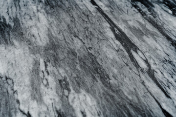 Gray marble texture with natural white veining patterns. Smooth, polished stone surface for countertops