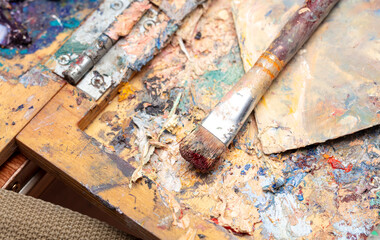 Multi-colored oil paints on the artist's table. Abstract background
