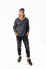 Naklejka premium Shot of smiling mature European man dressed in casual grey jumper looks directly at camera . Full height.
