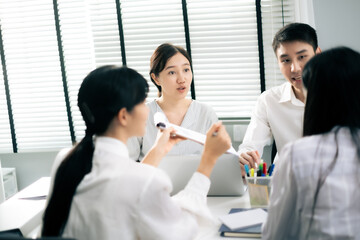 Asian Man and woman co-worker consult about work or team meeting at work with serious emotion.