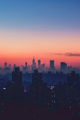 A city skyline silhouetted at dawn, with a softly blurred background of the first light breaking over buildings. 
