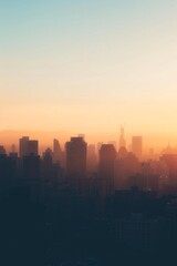 Fototapeta premium A city skyline silhouetted at dawn, with a softly blurred background of the first light breaking over buildings. 