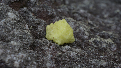 Close-up of sulfur rocks with a rough textured surface.