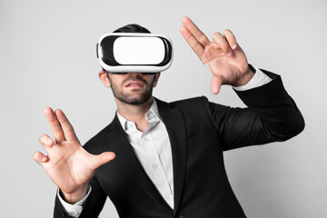 Skilled business man looking at data analysis while wearing VR glasses and suit. Project manager...