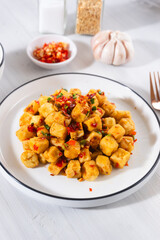 Tahu Cabe Garam or Salt and Pepper Tofu, Crispy Cubed Deep Fried Tofu with Garlic and Chilli Flakes. Perfect for recipe, article, or any cooking contents.