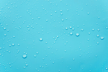 Water or rain drops on blue background 