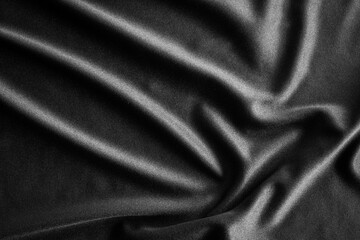 Black satin silk fabric background with luxury smooth texture background. 