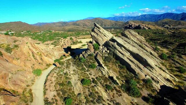 Aerial: Drone Panning Scenic Shot Of Vasquez Rocks In Eroded Desert On Sunny Day - Agua Dulce, California