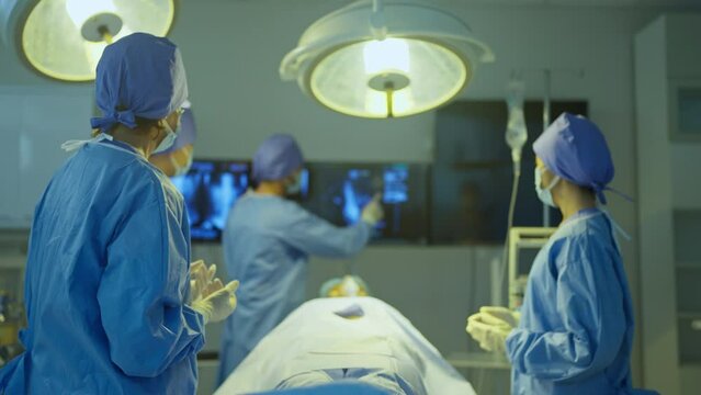 Doctor explain to his team about the process to treat patient in operation room of hospital.