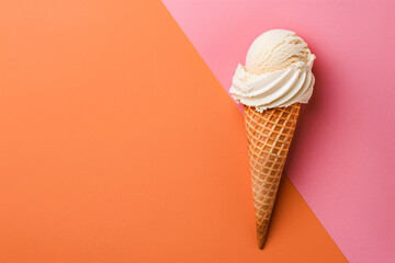 Photo of a single ice cream cone on an orange and pink background, minimal concept, flat lay view from above in studio lighting, pastel colors