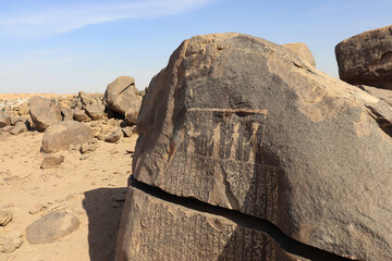 Ancient egyptian carvings and hieroglyphs carved on Famine Stela stones in Aswan, Egypt 