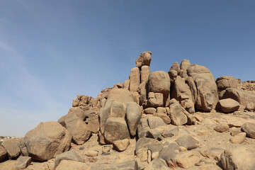 Ancient egyptian carvings and hieroglyphs on granite rocks near Famine Stela in Aswan, Egypt 