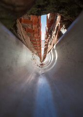 Interior of a PVC gutter at the confluence of a gable roof.