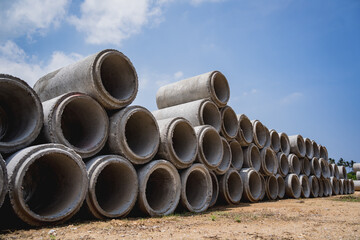 A stack of concrete ring pipes piled and creating a symmetrical arrangement