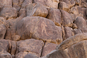 Ancient egyptian carvings and hieroglyphs on granite rocks near Famine Stela in Aswan, Egypt 