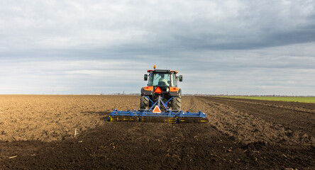 Tractor preparing the land for a new crop planting