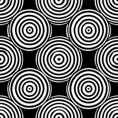 Bold black and white pattern featuring concentric circles creating a striking and hypnotic optical illusion effect. Seamless.
