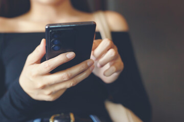 close up of young woman using mobile smart phone