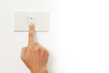 Turn off the light, close up female hand is closing the power switch. Save energy, reduce global...