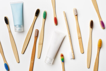 Top view of eco friendly bamboo toothbrushes and toothpaste tube on grey white, Natural organic personal accessories for tooth care, zero waste,  minimal style aesthetic pattern, colors toothbrush