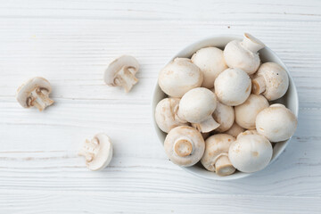 Many raw mushroom champignon  on wooden background