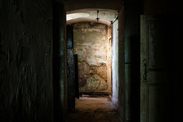 The corridor of an old gloomy house with shabby walls, a walk through scary places