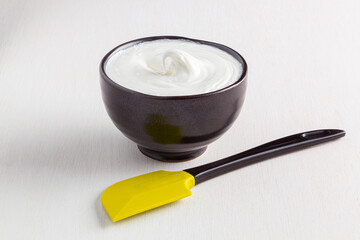 bowl with whipped egg whites on a white table..