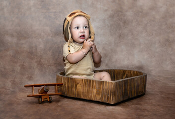 1-year-old baby with a pilot's cap and a toy airplane