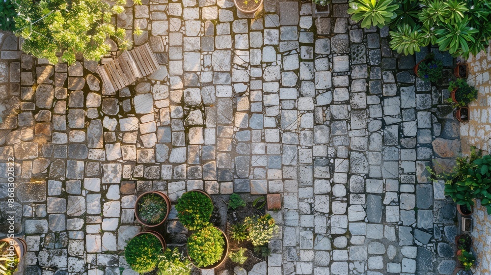 Sticker Close up aerial view of vintage exposed stone patio in sunlight